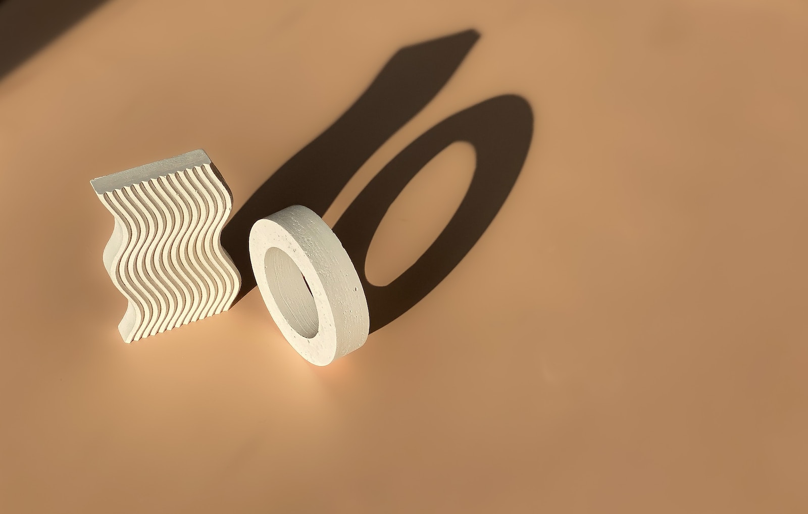 the shadow of a roll of toilet paper and a roll of toilet paper