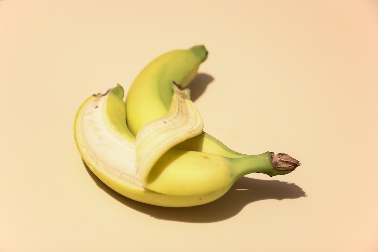 yellow banana fruit on white surface